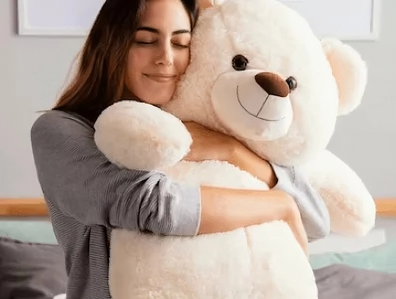a woman hugging a large teddy bear