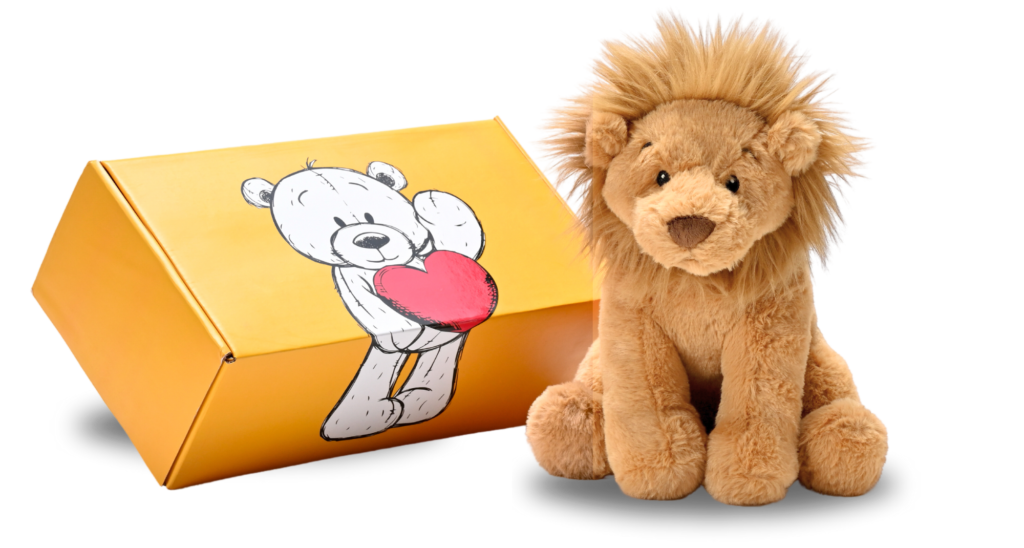 a stuffed lion next to a box