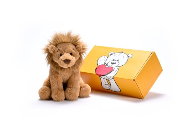 a stuffed lion next to a box