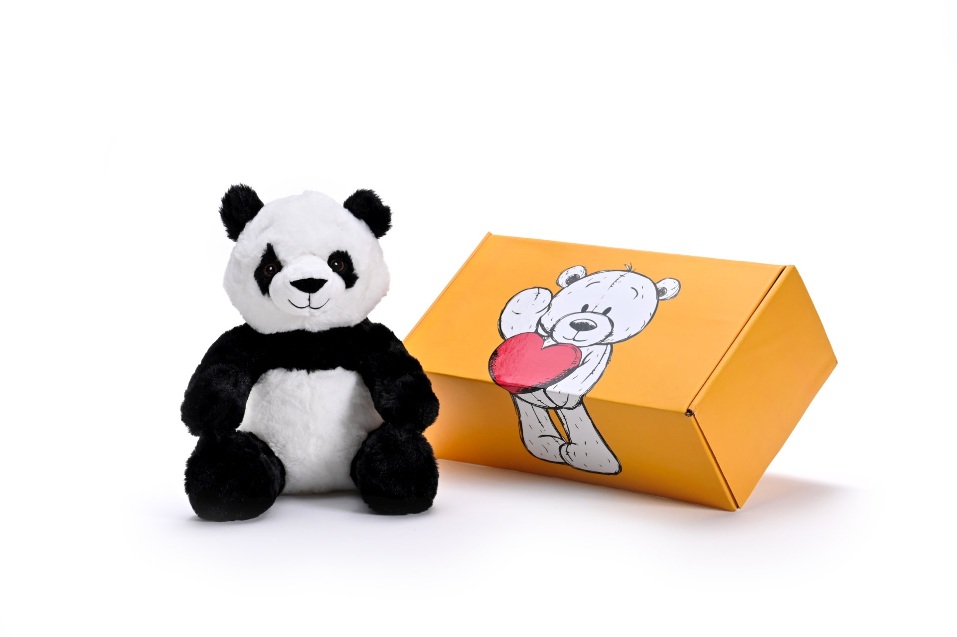 a stuffed panda soft toy next to a box