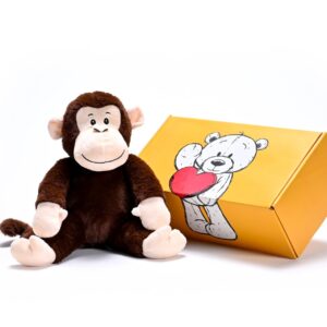 a stuffed monkey soft toy next to a box