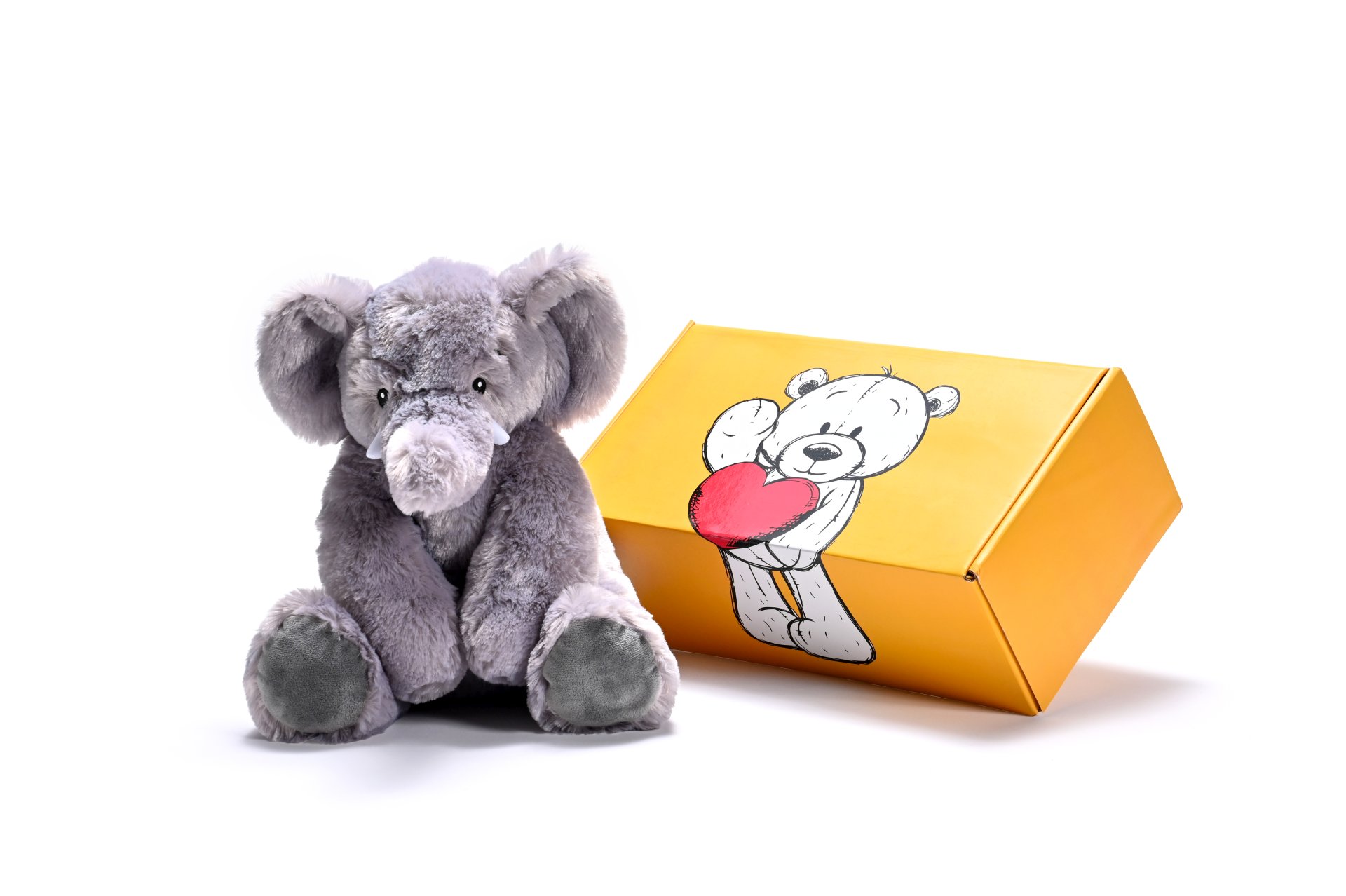 a stuffed elephant toy next to a box