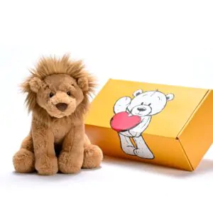 a stuffed lion next to a box