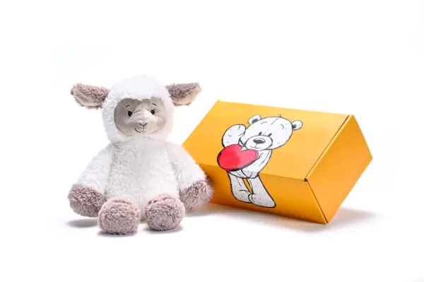 a stuffed sheep soft toy next to a box