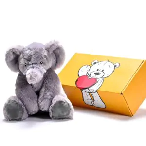 a stuffed elephant toy next to a box